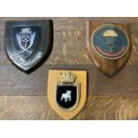 Three military wooden plaques. Bulldog, German parachute and Gurkha rifles. W:16cm x D:cm x H:18cm