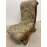 An antique upholstered nursing chair