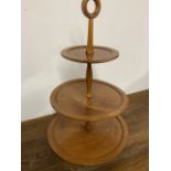 A three tier fruitwood cake stand W:40cm x D:40cm x H:70cm