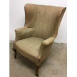 A 19th century high back, wing armchair with castors to front W:77cm x D:70cm x H:102cm