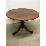 A mahogany tilt top circular table