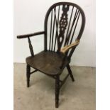 A 19th century part elm wheel back Windsor style arm chair together with a child's chair.