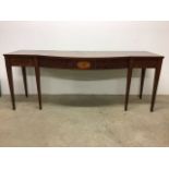 An Edwardian mahogany inlaid bow fronted serving table on tapered legs. W:214cm x D:74cm x H:85cm