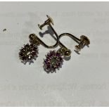 A pair of 9ct gold and ruby drop earrings. 2.7g.