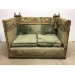 A late 19th early 20th century Parker Knoll style two seater drop arm sofa in period green velvet