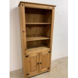 A modern pine set of shelves with cupboard below W:80cm x D:43cm x H:173cm