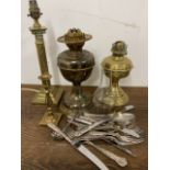 A brass column lamp with oils lamps and E.P.N.S cutlery