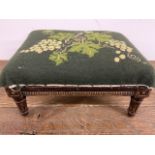 A small oak upholstered footstool. With upholstered date SMC 94.