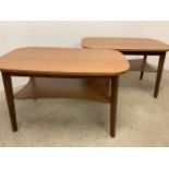 A pair of Formica topped tables with shelf. W:100cm x D:60cm x H:61cm