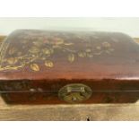 A Japanese leather painted jewellery box. W:29cm x D:17cm x H:11cm