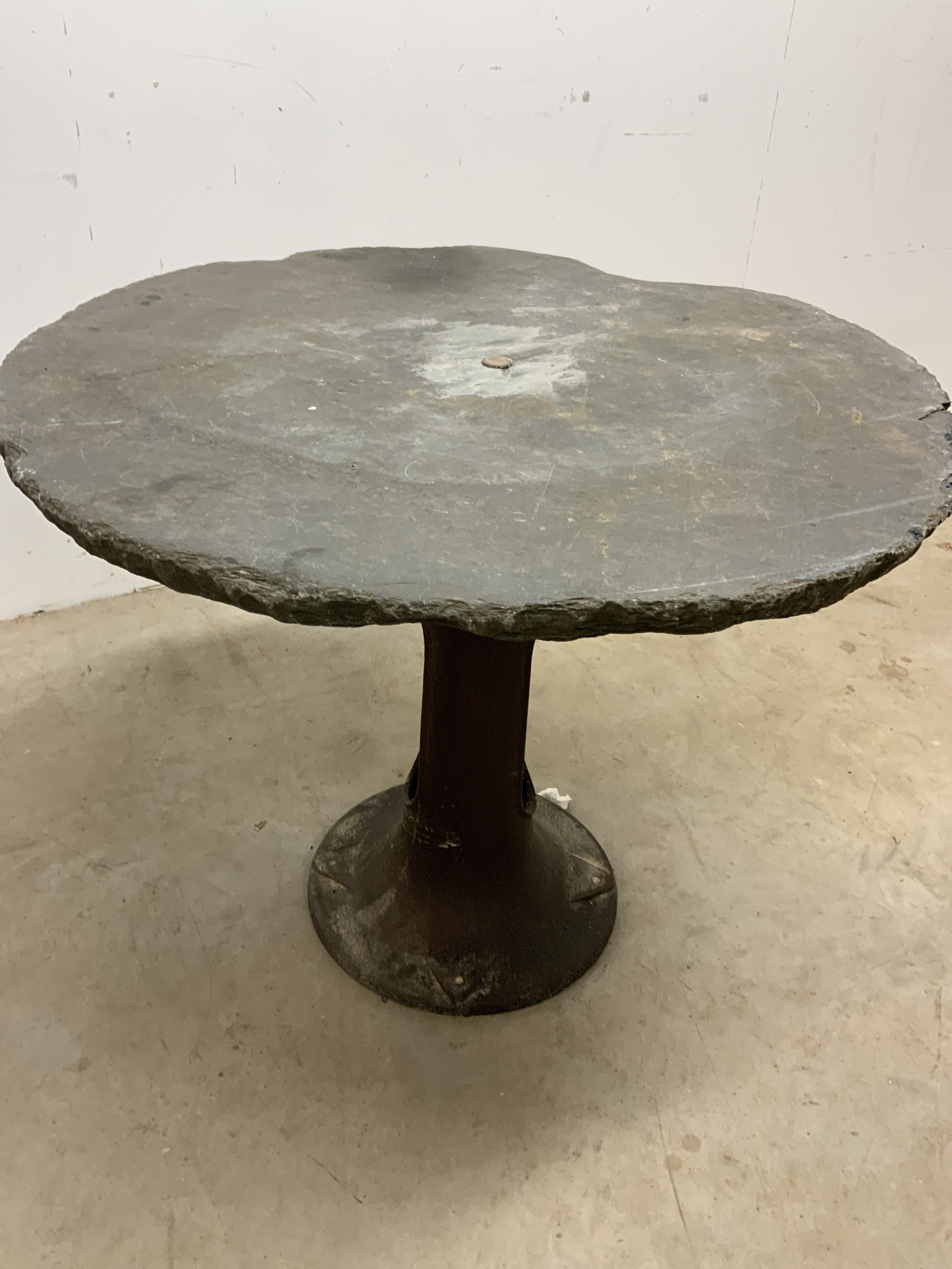 A slate topped circular garden table on metal base. W:77cm x D:77cm x H:62cm