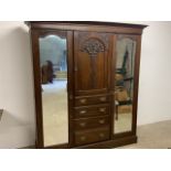 An art Nouveau gentleman's triple wardrobe with fitted interior linen drawers, brass handles. W: