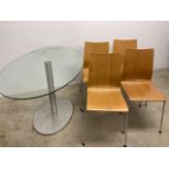 Four modern design stacking chairs and an ellipse shaped glass topped table. Chairs:W:40cm x D: