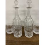 A near pair of decanters and 4 whiskey glasses