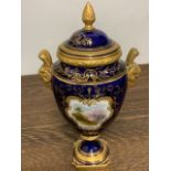 A Coalport porcelain lidded urn vase, decorated in Cobalt blue with gilt scrolls and a painted