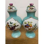 A pair of lidded vases hand painted with birds on branches. W:9cm x D:9cm x H:21cm