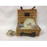 A wicker basket with a Alfred Meakin incomplete tea set: four tea cups, one plate, six side plates