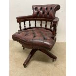 An antique leather oxblood red captains swivel office chair. W:65cm x D:57cm x H:83cm