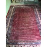 A Persian wool carpet 310cm x 215cm
