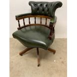 A green leather captains swivel office chair. W:65cm x D:57cm x H:84cm