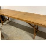 A long trestle table. W:237cm x D:64cm x H:76cm