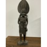 A hardwood tribal figure of an African lady W:20cm x D:10cm x H:77cm