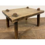 A small rustic pine stool. W:30cm x D:22cm x H:17cm W:30cm x D:22cm x H:17cm