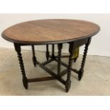 A small oak gate leg table with barley twist legs W:93cm x D:40cm x H:73cm extends to W:93cm x D:
