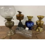 Various oil lamps, chimneys and a shade