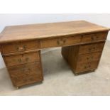 A Rustic pine pedestal desk. Brass handles. W:139cm x D:68cm x H:75cm