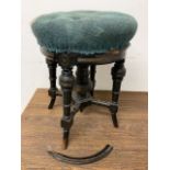 An ebonised revolving piano stool with gilded detailing. W:38cm x D:38cm x H:47cm