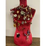 An upholstered mannequin with jewellery.