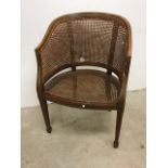 An Edwardian mahogany and rattan Bergere style tub chair with string inlaid decoration. W:62cm x D: