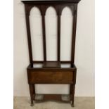 An Edwardian hall stand with metal trays and feet. Lift upon centre panel to drawer. W:97cm x D:26cm