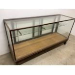 A large shop display showcase. Sliding doors to the rear with internal glass 2 piece shelf. W: