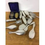 A collection of sterling silver backed dressing table items.