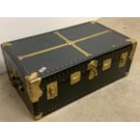 A fitted brass bound travelling trunk with leather handles and a key. W:92cm x D:53cm x H:35cm
