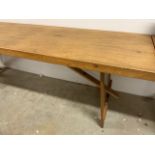 A long trestle table. W:237cm x D:64cm x H:76cm