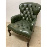 A green leather button back nursing chair with studwork finish. W:64cm x D:78cm x H:80cm