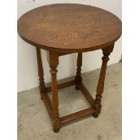 A circular oak occasional table. W:55cm x D:55cm x H:71cm