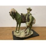 Resin horse and cowboy figure. W:34cm x D:18cm x H:30cm