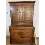A 19th century dark stained French Pine Kitchen cabinet with drop front and fitted interior. Drilled