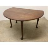 A mahogany drop leaf table with pad feet. W:44cm x D:122cm x H:71cm W:131cm x D:122cm x H:71cm