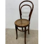 A bentwood stool with rattan seat.