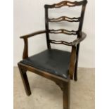 An oak ladder back arm chair with leather seat W:56cm x D:49cm x H:97cm