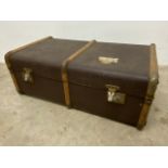 A Vintage wood bound travelling trunk. W:84cm x D:50cm x H:31cm