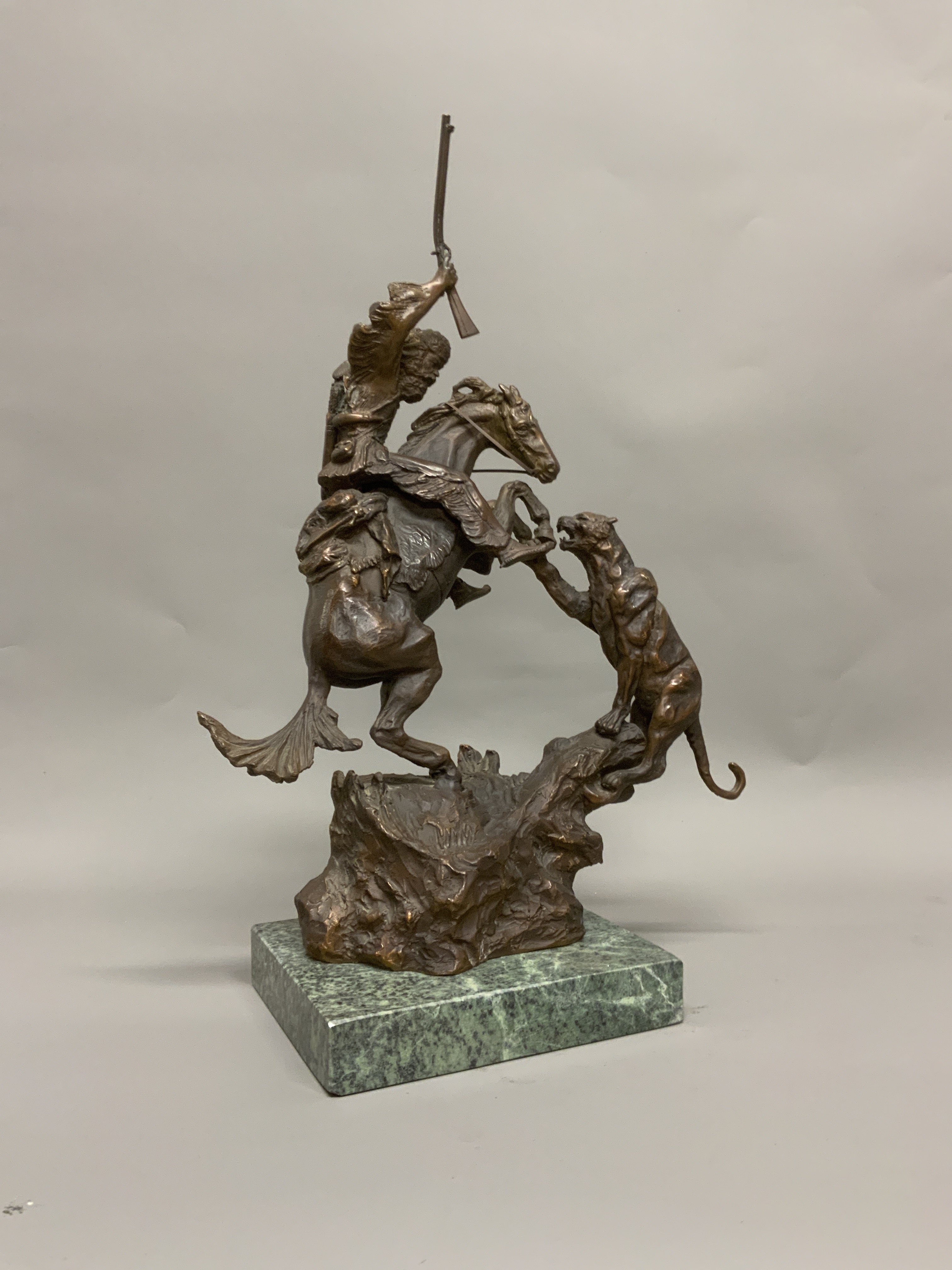 AFTER CHARLES MARION RUSSELL (1864-1926), a bronze model of a cowboy attacking a panther on