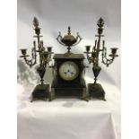 A late 19th early 20th century French slate and marble mantle clock and garniture. Movement