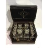 A 19th century French Napoleon III black lacquer liqueur box with brass and mother of pearl inlay