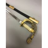 An early 20th century naval dress sword with gilt basket and shagreen grip with inscription for WJ